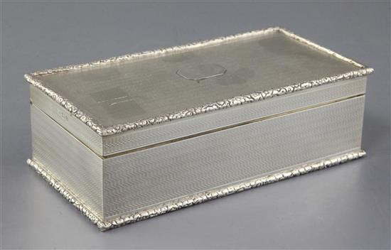 A George V engine turned silver rectangular cigarette box, retailed by Asprey & Co,